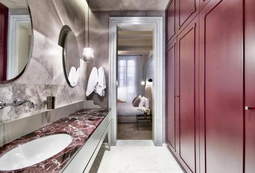 a bathroom with a sink and a mirror at 10 Strait Street Apartments in Valletta