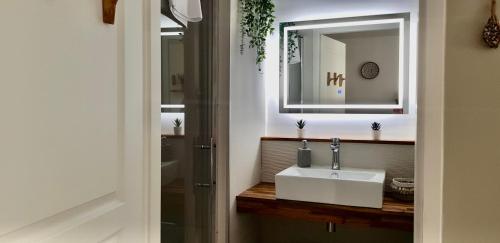 a bathroom with a sink and a mirror at Casa Tulum in Irigny