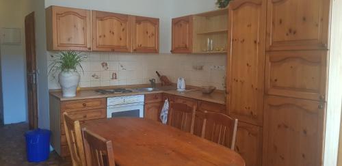a kitchen with wooden cabinets and a wooden table with a wooden table at Apartmán náměstí 2 in Horní Blatná