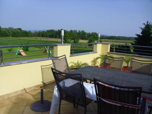 a patio with a table and chairs on a balcony at Gostilna in prenočišče KOCJAN in Bizeljsko