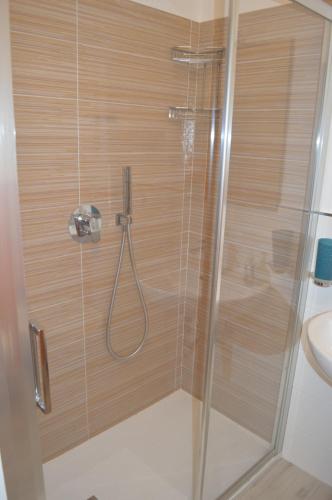 a shower with a glass door in a bathroom at Ad un passo dal mare in Porto SantʼElpidio