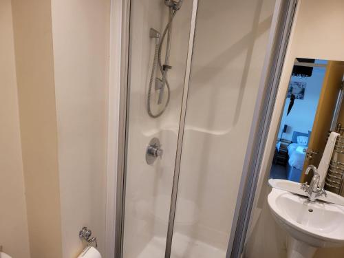 a bathroom with a shower and a sink at Vetrelax Colchester Apartment in Colchester