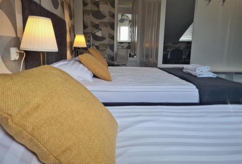 a hotel room with two beds with pillows at Pensjonat Retro in Łomża