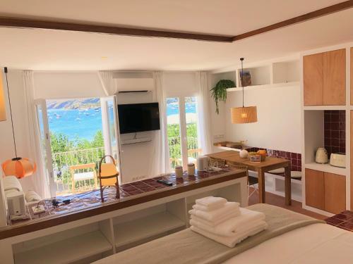 a kitchen with a desk with a view of the ocean at Beachfront SUITE in CADAQUES center in Cadaqués