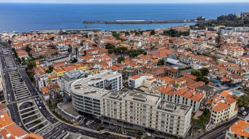 an aerial view of a city with buildings and the ocean at SOCIAL LODGE - Centro do Funchal in Funchal