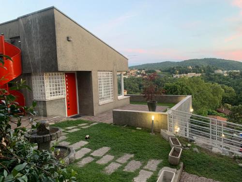 a small house with a red door on a balcony at Volta's Dream in Como