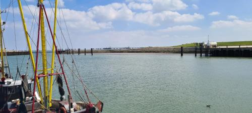 a boat in the water next to a dock at Lichtblick in Wangerland