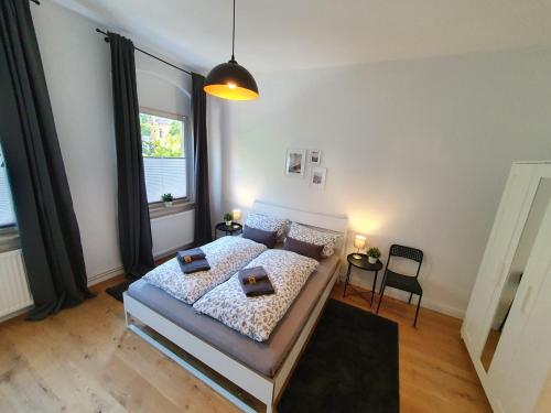 a bedroom with a bed and a large window at Altstadt-Ferienwohnungen Braunschweig in Braunschweig