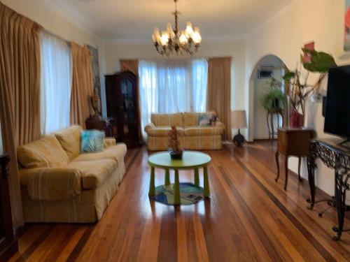 a living room with a couch and a table at Reservoir 短租 in Melbourne