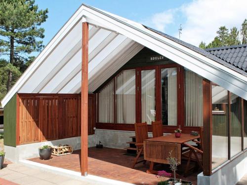 a pavilion with a table on a patio at 5 person holiday home in R m in Bolilmark