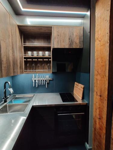 a kitchen with a sink and a stove top oven at Pasta Amber Lux in Liepāja