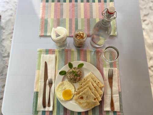 a plate of food with eggs and bread on a table at Manta Stay Thoddoo, Maldives in Thoddoo