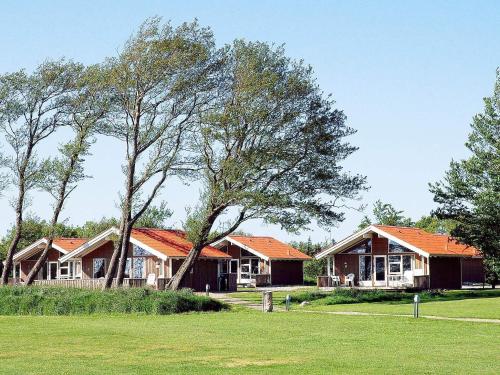 a group of houses with trees in a field at 6 person holiday home in Sk rb k in Skærbæk