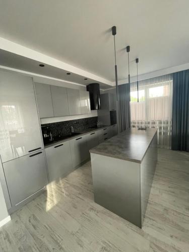 a kitchen with a island in the middle of a room at Solanki Apartament Solankowa Aleja Loft in Inowrocław