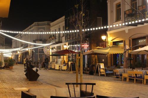 a city street with lights and tables and chairs at Q&B House in Tbilisi City
