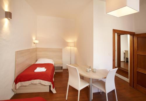 a small room with a bed and a table at Residence Muzeum Vltavínů in Český Krumlov