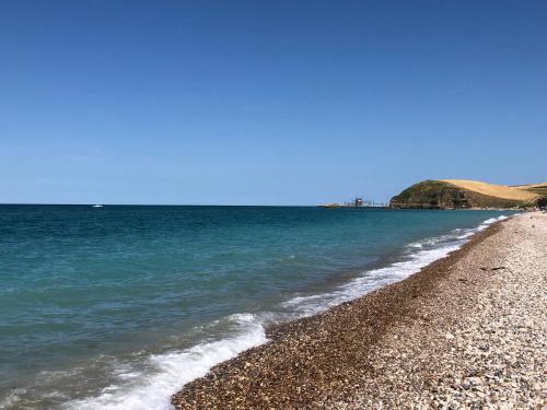 a beach with blue water and a rocky shore at Agriturismo La Costa dei Trabocchi in Torino di Sangro