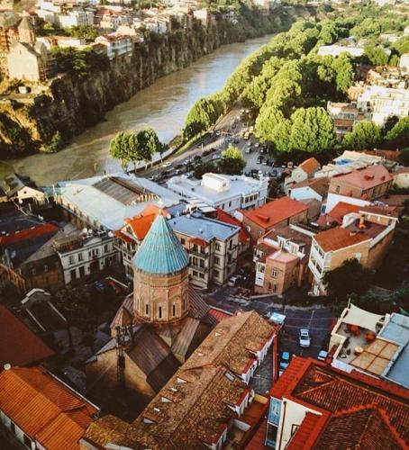 an aerial view of a city with a river at Q&B House in Tbilisi City