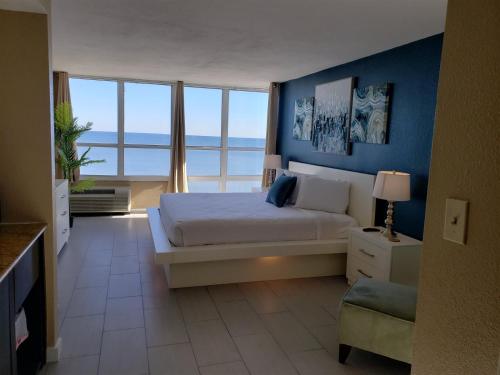 a bedroom with a bed with a view of the ocean at Newly Renovated Beachfront Studio Sun N Sand 1014 in Myrtle Beach