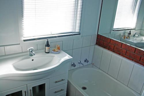 a bathroom with a sink and a bath tub at Garland Grove in Ocean Grove