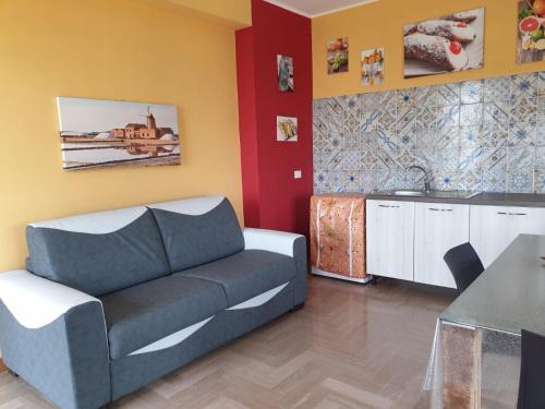 a living room with a couch and a table at Anastasia Villas-B&B in Lido Signorino