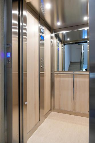 a walk in closet with a mirror and a door at Hotel Auditorium in Bari