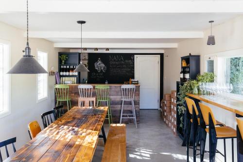 a restaurant with wooden tables and chairs and a bar at פטריוט -יקב ננה in Mitzpe Ramon