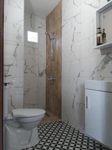 een witte badkamer met een toilet en een douche bij Casa Magnolia Boutique Rooms in Kuşadası