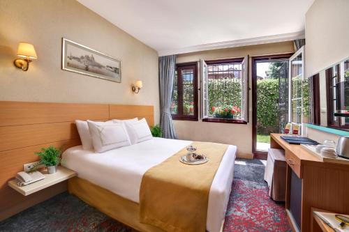 a hotel room with a bed and a desk at Almina Hotel - Special Class in Istanbul