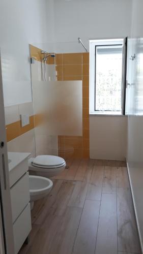 a bathroom with a toilet and a window at marinella in Lamezia Terme