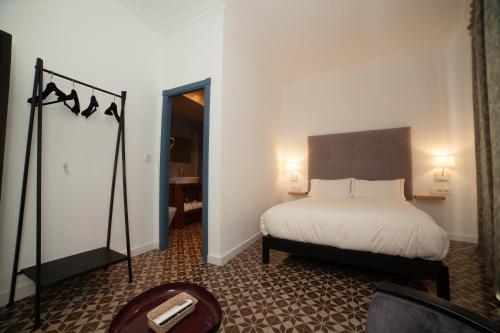 Postel nebo postele na pokoji v ubytování Apartahotel Siglo XIX