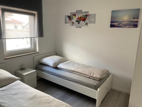 a small bedroom with a bed and a window at Ferienwohnung Air-Base - Playmobil, Messe, Nürnberg, Fürth, Ansbach in 20 Minuten erreichbar in Großhabersdorf
