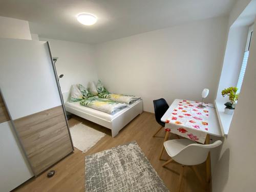 a small room with a table and a couch at Ferienwohnung Laimer, Radau 37 in St. Wolfgang