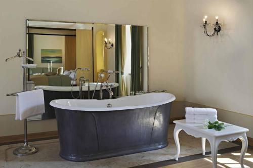 a large bathroom with a tub and a mirror at Barockschloss Rammenau in Rammenau