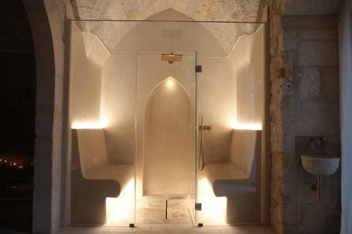 a glass shower stall in a bathroom with lights at Lanime - Bed in Spa in Sogliano Cavour