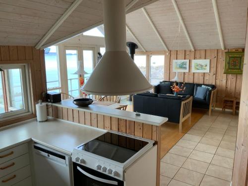 a kitchen and living room with a stove top oven at Loff Holiday Houses in Aabenraa