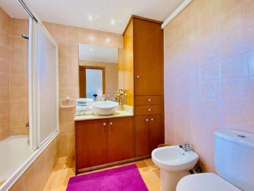 a bathroom with a sink and a toilet and a tub at C329 Estrella Verde by Mallorca Villa Selection in Alcudia