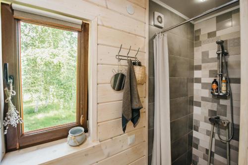 a bathroom with a shower and a window at Shanti House in Migovo