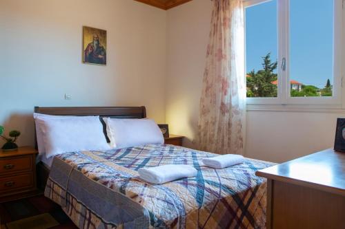 ein Schlafzimmer mit einem Bett mit zwei Kissen darauf in der Unterkunft Konstantino's House in Áyios Ilías