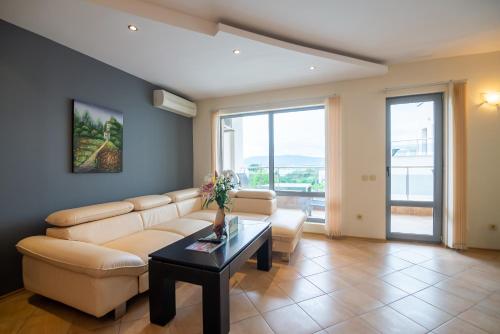 a living room with a couch and a table at Byala Panorama Resort in Byala