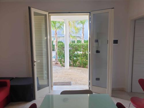 a living room with a door open to a patio at Lucrezia relax in Nardò