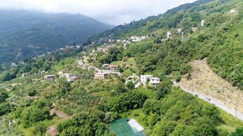 an aerial view of a mountain with houses and a road at D & K Guest House in Makrirrákhi