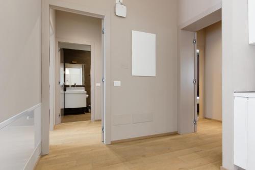an open hallway with white walls and wooden floors at JOIVY Treviso Vittoria in Treviso