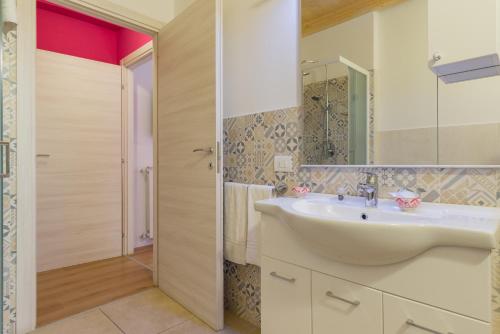 a bathroom with a sink and a mirror at Giardino Giusti House & Court in Verona
