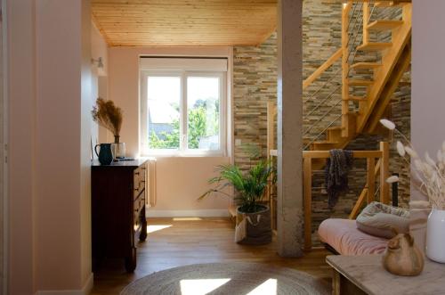a living room with a staircase and a window at SAVANNAH in Saint Malo