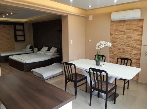Zimmer mit einem Tisch und Stühlen sowie einem Schlafzimmer in der Unterkunft Vanessza apartman in Siófok