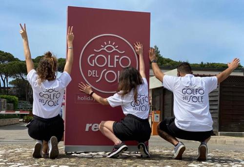 a group of people in front of a sign at Golfo del Sole Hotel & Holiday Resort in Follonica