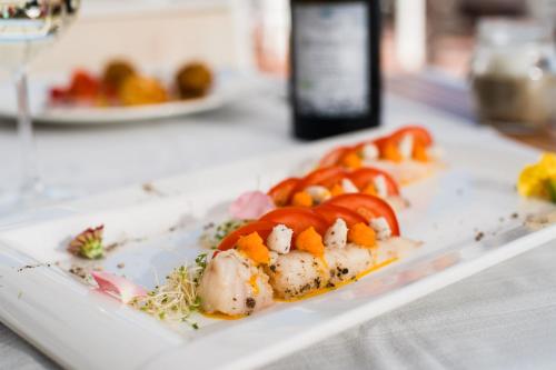 a plate of food on a table with vegetables at Golfo del Sole Hotel & Holiday Resort in Follonica