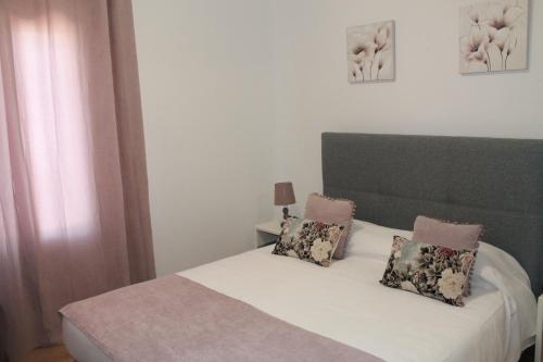 a bedroom with a bed with two pillows on it at Girassol Alojamento Local in Montemor-o-Novo