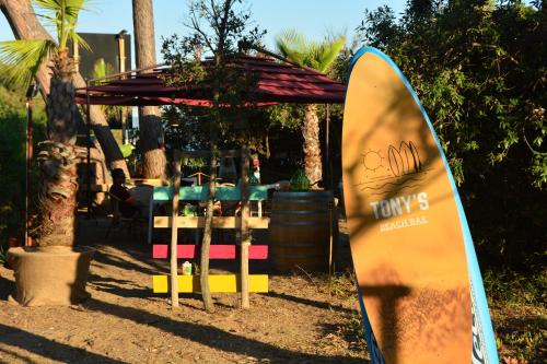 a surfboard is standing in front of a table at Golfo del Sole Hotel & Holiday Resort in Follonica